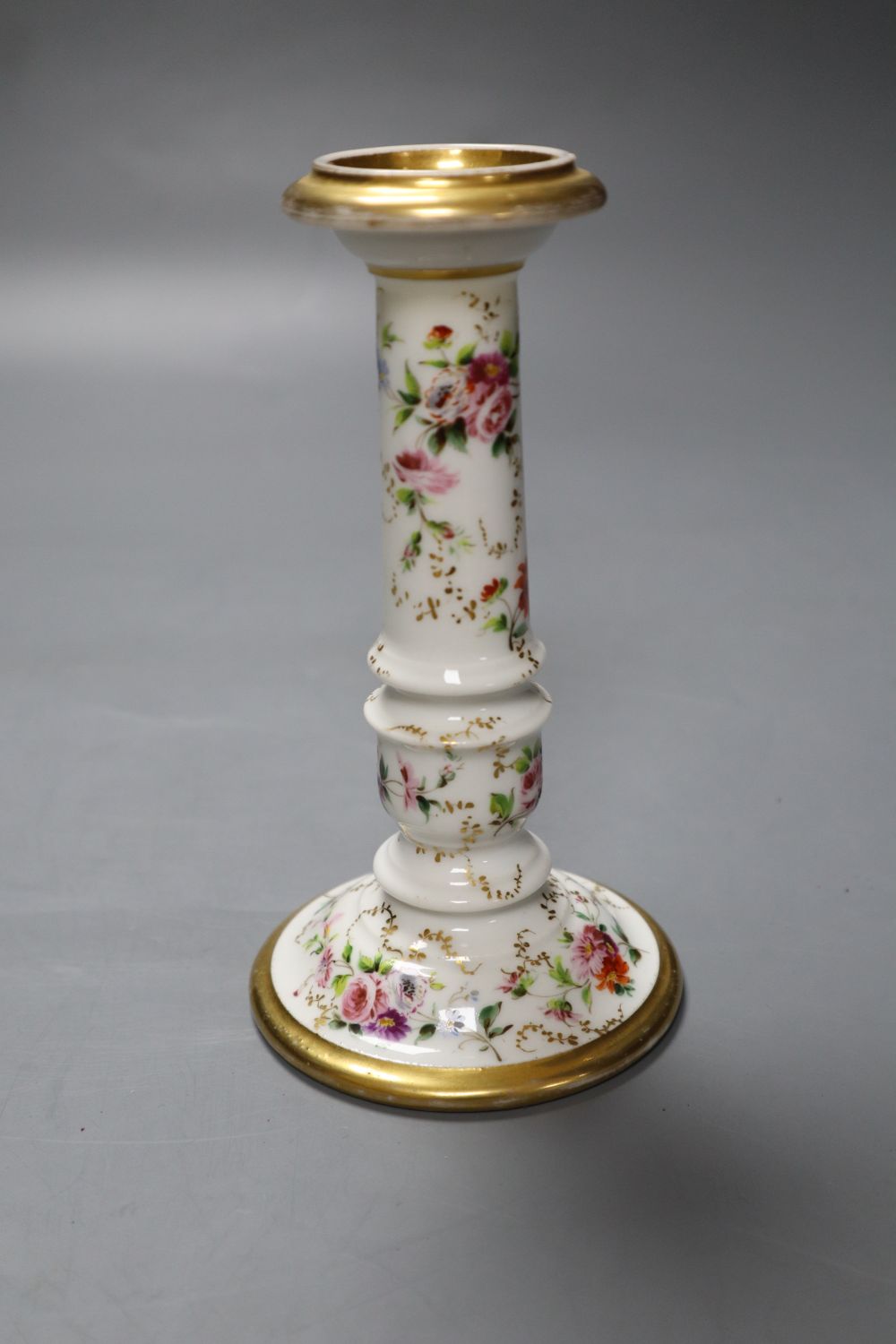 Joseph Petit. A floral and gilt decorated candlestick, height 16cm
